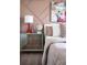 Charming bedroom featuring a mirrored nightstand, stylish artwork, and a cozy, inviting aesthetic at 37029 Sagemoor Dr, Zephyrhills, FL 33541