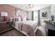 Charming bedroom featuring a mirrored nightstand, stylish artwork, and a cozy, inviting aesthetic at 37029 Sagemoor Dr, Zephyrhills, FL 33541