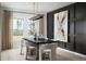 Elegant dining room features a modern table, stylish chairs, striking light fixture and large view windows at 37029 Sagemoor Dr, Zephyrhills, FL 33541