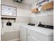 Laundry room with side-by-side washer and dryer, built-in shelving, and modern decor at 37029 Sagemoor Dr, Zephyrhills, FL 33541