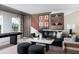 This living room offers a sleek black sofa, modern decor, and a pool table off to the side at 37029 Sagemoor Dr, Zephyrhills, FL 33541