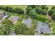 Aerial view of homes in a neighborhood, featuring lush landscaping, screened pools, and fenced yards at 4418 Gentrice Dr, Valrico, FL 33596