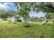 Spacious backyard with lush green grass and a white picket fence; ideal for outdoor enjoyment at 4418 Gentrice Dr, Valrico, FL 33596