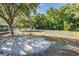 Outdoor basketball court ready for play, surrounded by lush greenery and mature trees at 4418 Gentrice Dr, Valrico, FL 33596