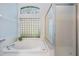 Clean bathroom highlighting a soaking tub with glass block window and a separate shower at 4418 Gentrice Dr, Valrico, FL 33596
