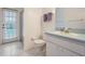 Bright bathroom with a sink and toilet, featuring a view of the pool area through the glass door at 4418 Gentrice Dr, Valrico, FL 33596