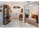 Bright foyer features white tile flooring, chandelier, and view into living space beyond double doors at 4418 Gentrice Dr, Valrico, FL 33596