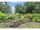 Lush garden with colorful flowers, decorative statues, and meticulous landscaping at 4418 Gentrice Dr, Valrico, FL 33596
