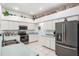 Bright kitchen features white cabinets, stainless steel appliances, and whimsical decor accents at 4418 Gentrice Dr, Valrico, FL 33596