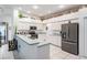 Modern kitchen with white cabinetry, stainless steel appliances, and ample countertop space for meal preparation at 4418 Gentrice Dr, Valrico, FL 33596