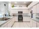 Well-lit kitchen with white cabinets, stainless steel appliances, and light tile flooring at 4418 Gentrice Dr, Valrico, FL 33596