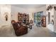 Cozy living room with comfortable seating, bookshelves, and access to the lanai overlooking the pool area at 4418 Gentrice Dr, Valrico, FL 33596