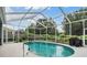 Enjoy the Florida sunshine in this screened-in pool with lush landscaping and an outdoor grill at 4418 Gentrice Dr, Valrico, FL 33596