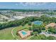 Aerial view showcasing the community pool, tennis courts, and lush green spaces at 4506 La Capri Ct, Tampa, FL 33611