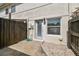 Private back entrance with a patio area, bordered by stone and wooden fencing at 4506 La Capri Ct, Tampa, FL 33611