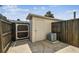 Enclosed backyard featuring a storage shed and an air conditioning unit at 4506 La Capri Ct, Tampa, FL 33611