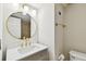Bathroom with a modern vanity, round mirror and contemporary lighting at 4506 La Capri Ct, Tampa, FL 33611