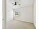 Bright bedroom with a ceiling fan, carpet floors, and a window with natural light at 4506 La Capri Ct, Tampa, FL 33611