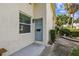 Inviting condo front door with a tranquil color, complemented by a small garden and walkway at 4506 La Capri Ct, Tampa, FL 33611