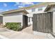 Charming townhouse entrance with a rustic wooden gate and lush greenery at 4506 La Capri Ct, Tampa, FL 33611