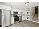 Efficient kitchen featuring stainless steel appliances, crisp white cabinets, in-unit washer and dryer, and nearby stairs at 4506 La Capri Ct, Tampa, FL 33611