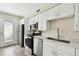 Well-lit kitchen features stainless steel appliances and white cabinets, offering a sleek and functional space at 4506 La Capri Ct, Tampa, FL 33611