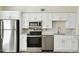 Modern kitchen featuring stainless steel appliances, white cabinets, and sleek countertops at 4506 La Capri Ct, Tampa, FL 33611