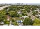 Aerial view of property amidst lush greenery with the cityscape skyline visible in the distance at 502 E Robles St, Tampa, FL 33602