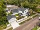 Aerial view of a two-story house with garage, showcasing its new roof, yard, proximity to mature trees at 502 E Robles St, Tampa, FL 33602