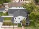 Aerial view of a two-story house with garage, showcasing its new roof, yard and mature trees at 502 E Robles St, Tampa, FL 33602