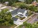 An aerial view of a house with a detached garage and lush backyard landscaping in a residential area at 502 E Robles St, Tampa, FL 33602