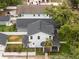 Aerial view highlighting a two-story home, detached garage, and a meticulously landscaped yard at 502 E Robles St, Tampa, FL 33602