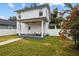 Spacious backyard with a covered patio, seating, and a well-maintained lawn for outdoor enjoyment at 502 E Robles St, Tampa, FL 33602