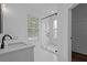 Clean, bright bathroom with a glass-enclosed shower featuring white subway tile and a decorative accent wall at 502 E Robles St, Tampa, FL 33602