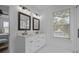 Bright bathroom featuring a double sink vanity, modern fixtures, and natural light from the window at 502 E Robles St, Tampa, FL 33602