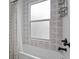 Close-up of bathtub with decorative tile and modern fixtures at 502 E Robles St, Tampa, FL 33602