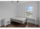 Bedroom with wood-look floors featuring two windows for lots of natural light and a ceiling fan at 502 E Robles St, Tampa, FL 33602