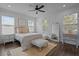 Cozy bedroom with a ceiling fan, multiple windows, and stylish furnishings at 502 E Robles St, Tampa, FL 33602