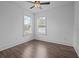 Bright bedroom featuring wood floors, two windows, and a ceiling fan for comfortable living at 502 E Robles St, Tampa, FL 33602