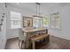 Charming dining area with a wooden table, bench seating, decorative mirror, and bright windows at 502 E Robles St, Tampa, FL 33602
