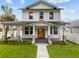 Stunning two-story home with a welcoming front porch, manicured lawn, and beautiful landscaping at 502 E Robles St, Tampa, FL 33602