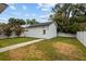 Detached garage with a crisp white exterior and well-maintained lawn surrounded by a white fence at 502 E Robles St, Tampa, FL 33602