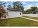 Exterior view of a detached garage featuring a well-maintained lawn and manicured landscape at 502 E Robles St, Tampa, FL 33602