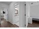 Hallway leading to a bathroom with bright white vanity and modern fixtures at 502 E Robles St, Tampa, FL 33602