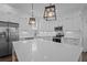 Bright kitchen features white cabinets, stainless steel appliances, an island, and stylish pendant lighting at 502 E Robles St, Tampa, FL 33602