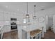 Bright kitchen features a center island with barstool seating and modern appliances at 502 E Robles St, Tampa, FL 33602