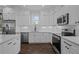 Modern kitchen featuring stainless steel appliances, bright white cabinets and backsplash at 502 E Robles St, Tampa, FL 33602