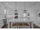 Bright kitchen with a center island featuring barstool seating and elegant pendant lighting at 502 E Robles St, Tampa, FL 33602