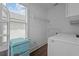 Bright laundry room featuring vintage-style mini refrigerator and modern washer and dryer at 502 E Robles St, Tampa, FL 33602