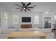 Comfortable living room with a ceiling fan, large windows, and a view into the modern kitchen at 502 E Robles St, Tampa, FL 33602